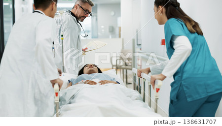 Doctors, patient and people push hospital bed, consulting and talking about healthcare service, wellness or surgery. Medical emergency, cooperation and hospital team, nurses or surgeon helping client Doctors, patient and people push hospital bed, consulting and talking about healthcare service, wellness or surgery. Medical emergency, cooperation and hospital team, nurses or surgeon helping client 138631707