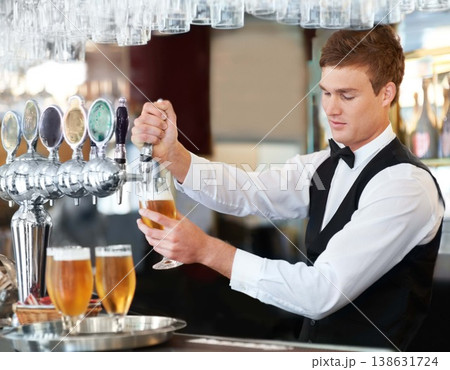 Man, bartender and waiter with beer at pub, restaurant or event for happy hour, hospitality industry or customer service. Young barman, server or catering employee with alcohol drinks in glasses Man, bartender and waiter with beer at pub, restaurant or event for happy hour, hospitality industry or customer service. Young barman, server or catering employee with alcohol drinks in glasses 138631724