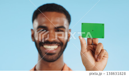 Man, credit card and happy with green screen in studio for mockup, bank logo and face by blue background. Person, space and chromakey with tracking markers for fintech brand, review or promotion 138631828