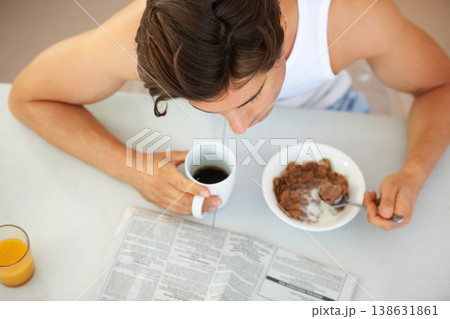 Top view, home and man with breakfast, newspaper and eating with information, health and coffee. Person, apartment and guy with newsletter, morning meal and reading with wellness and orange juice 138631861