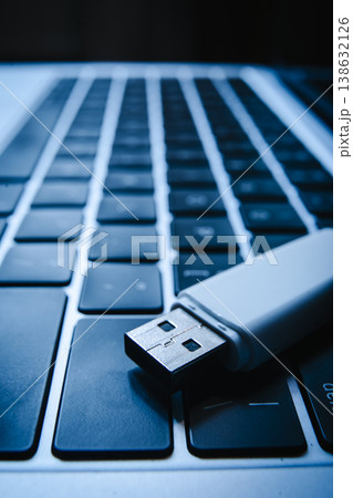 USB flash drive lying on a laptop keyboard as a concept of cyber security and digital data protection USB flash drive lying on a laptop keyboard as a concept of cyber security and digital data protection 138632126