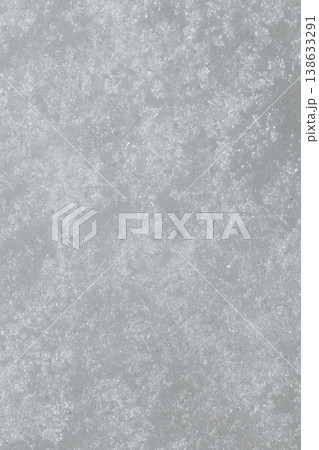 Snow Texture Close-Up. White Winter Snow Surface with Crystalline Pattern and Frost Details. Macro close-up view of natural snow texture showing detailed crystalline structure and frost patterns on wh Snow Texture Close-Up. White Winter Snow Surface with Crystalline Pattern and Frost Details. Macro close-up view of natural snow texture showing detailed crystalline structure and frost patterns on wh 138633291