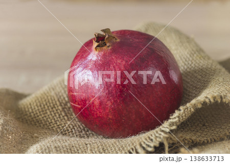 A Pomegranate or grenade on a burlap background, close up 138633713