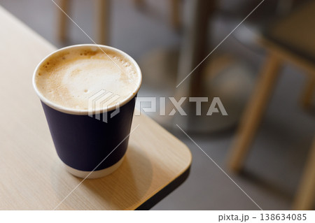 Cup of hot milk latte coffee on table by the window. Cup of hot milk latte coffee on table by the window. 138634085