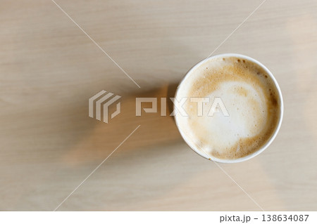 Cup of hot milk latte coffee on table by the window. Cup of hot milk latte coffee on table by the window. 138634087