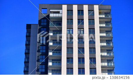 Exterior of a high modern multi-story apartment building - facade, windows and balconies. 138634156