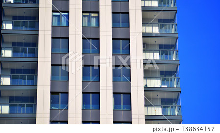 Exterior of a high modern multi-story apartment building - facade, windows and balconies. 138634157
