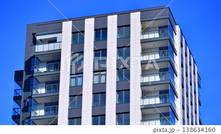 Exterior of a high modern multi-story apartment building - facade, windows and balconies. 138634160