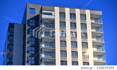Exterior of a high modern multi-story apartment building - facade, windows and balconies. 138634164