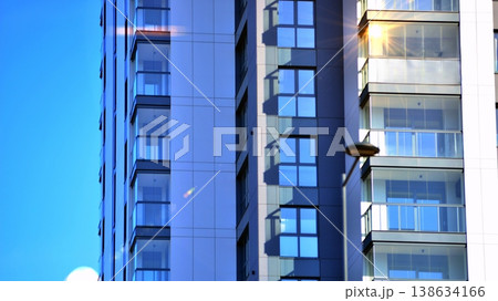 Exterior of a high modern multi-story apartment building - facade, windows and balconies. 138634166