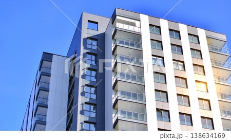 Exterior of a high modern multi-story apartment building - facade, windows and balconies. 138634169