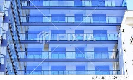 Exterior of a high modern multi-story apartment building - facade, windows and balconies. 138634173