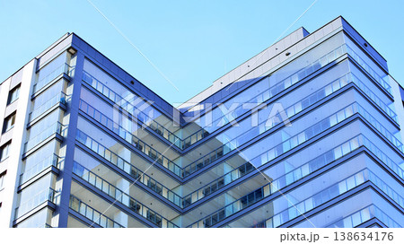 Exterior of a high modern multi-story apartment building - facade, windows and balconies. Exterior of a high modern multi-story apartment building - facade, windows and balconies. 138634176