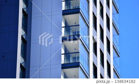 Exterior of a high modern multi-story apartment building - facade, windows and balconies. 138634182