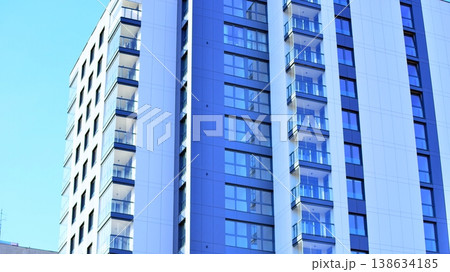 Exterior of a high modern multi-story apartment building - facade, windows and balconies. Exterior of a high modern multi-story apartment building - facade, windows and balconies. 138634185
