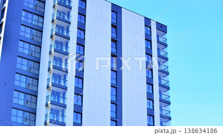 Exterior of a high modern multi-story apartment building - facade, windows and balconies. 138634186