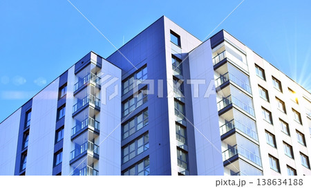 Exterior of a high modern multi-story apartment building - facade, windows and balconies. 138634188