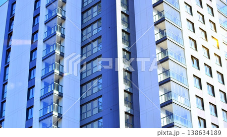 Exterior of a high modern multi-story apartment building - facade, windows and balconies. 138634189