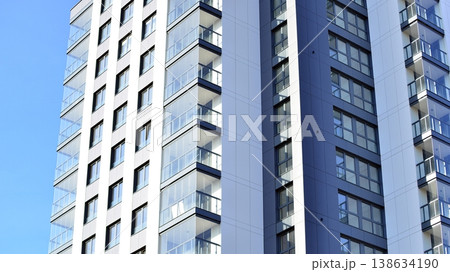 Exterior of a high modern multi-story apartment building - facade, windows and balconies. 138634190
