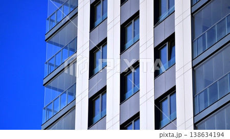 Exterior of a high modern multi-story apartment building - facade, windows and balconies. Exterior of a high modern multi-story apartment building - facade, windows and balconies. 138634194