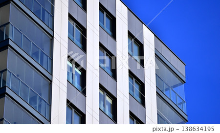 Exterior of a high modern multi-story apartment building - facade, windows and balconies. 138634195