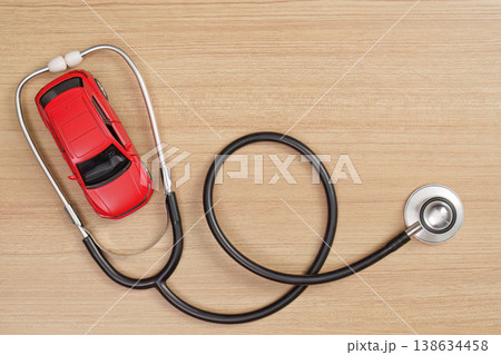 Medical concept with stethoscope and toy car on wooden background 138634458