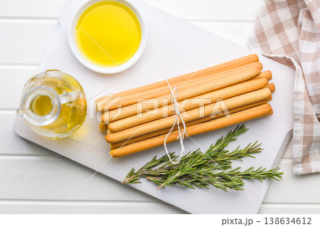 Bundle Of Crispy Breadsticks With Rosemary And Olive Oil Dip On White Wooden Table 138634612
