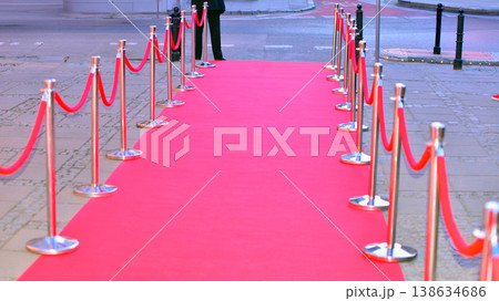 Long red carpet between rope barriers on entrance. 138634686