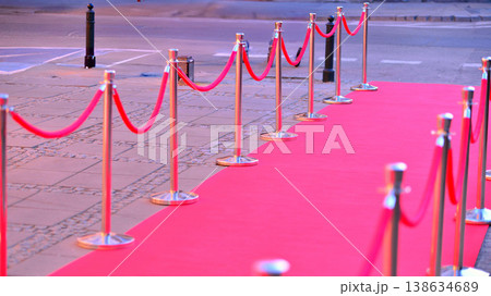 Long red carpet between rope barriers on entrance. Long red carpet between rope barriers on entrance. 138634689