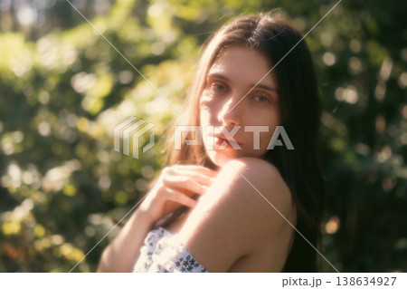 Soft portrait of young woman in warm woodland light Soft portrait of young woman in warm woodland light 138634927