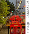 The vacancy chairs and tables at the food street shop with blurred traffic lights in background. 138635103