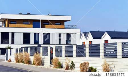 Terraced family homes in newly developed housing estate. The real estate market in the suburbs. New single family houses in a new development area. Residential homes with modern facade. Terraced family homes in newly developed housing estate. The real estate market in the suburbs. New single family houses in a new development area. Residential homes with modern facade. 138635273