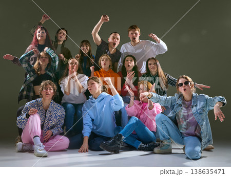 Group of friends reacting with loud emotions and gestures in expressive studio scene. 138635471