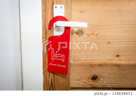 Privacy Notice Hanging On Wooden Door Handle With DO NOT DISTURB Sign Privacy Notice Hanging On Wooden Door Handle With DO NOT DISTURB Sign 138636651