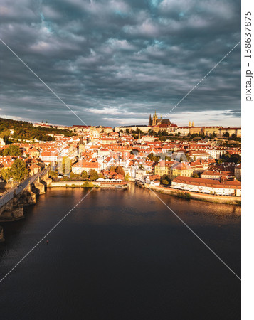 Early dawn reveals the stunning skyline of Prague, showcasing the historic Charles Bridge and the majestic Prague Castle. The calm Vltava River reflects the colors of the sky. Early dawn reveals the stunning skyline of Prague, showcasing the historic Charles Bridge and the majestic Prague Castle. The calm Vltava River reflects the colors of the sky. 138637875