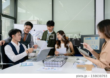 financial asian advisor showing plan of investment to clients in the consultancy office. financial asian advisor showing plan of investment to clients in the consultancy office. 138638763