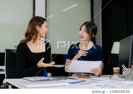 Professional woman lnvestor and business team using digital devices in modern office. 138638830