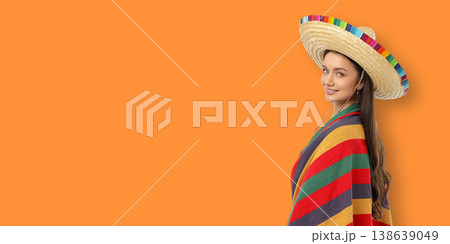 Cinco de Mayo, A young woman smiles wearing a poncho and sombrero Cinco de Mayo, A young woman smiles wearing a poncho and sombrero 138639049