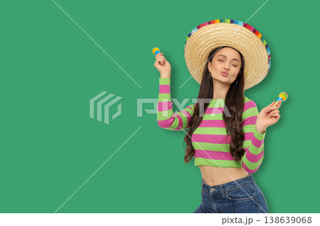 Cinco de Mayo, A young woman dances with maracas in a festive setting 138639068