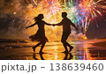 Couple dancing under fireworks holding hands with colorful reflections and motion blur in night 138639460