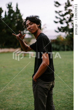 Casual Young Man Making Hand Gesture in Grassy Park Casual Young Man Making Hand Gesture in Grassy Park 138639611