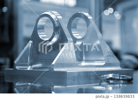 Metal part manufactured using CNC machining. Part made by metalworking CNC machine from metal. Polished aluminum or stainless steel. High-precision milling followed by polishing. Production technology 138639833