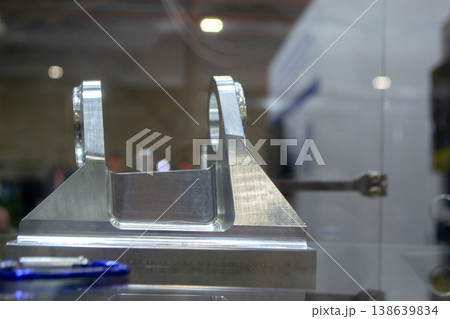 Metal part manufactured using CNC machining. Part made by metalworking CNC machine from metal. Polished aluminum or stainless steel. High-precision milling followed by polishing. Production technology Metal part manufactured using CNC machining. Part made by metalworking CNC machine from metal. Polished aluminum or stainless steel. High-precision milling followed by polishing. Production technology 138639834