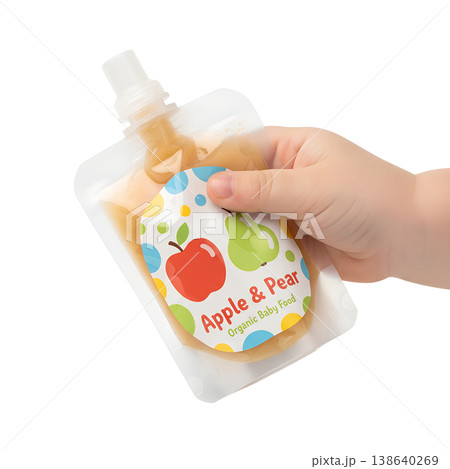 Baby's small hand gripping a soft squeeze pouch of organic apple and pear baby food, representing self-feeding, weaning, and healthy infant nutrition 138640269