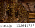 Dried herbs are hung on wooden beams in an old space for preservation during a late afternoon 138641727