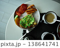 Enjoying avocado toast with coffee and sides at a cozy cafe in the morning light 138641741
