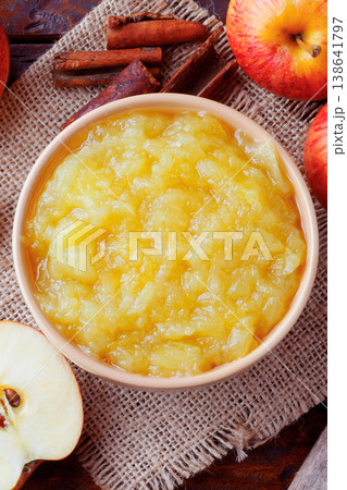 homemade apple sauce or apple puree in ceramic bowl over rustic wooden table. top view 138641797