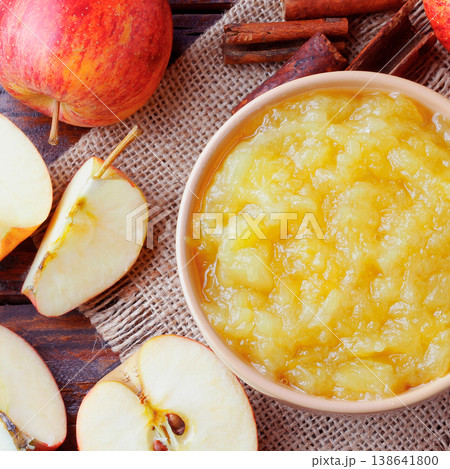 homemade apple sauce or apple puree in ceramic bowl over rustic wooden table. top view homemade apple sauce or apple puree in ceramic bowl over rustic wooden table. top view 138641800