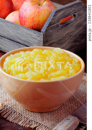 homemade apple sauce or apple puree in ceramic bowl over rustic wooden table. top view 138641801