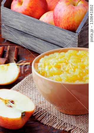 homemade apple sauce or apple puree in ceramic bowl over rustic wooden table. top view 138641802